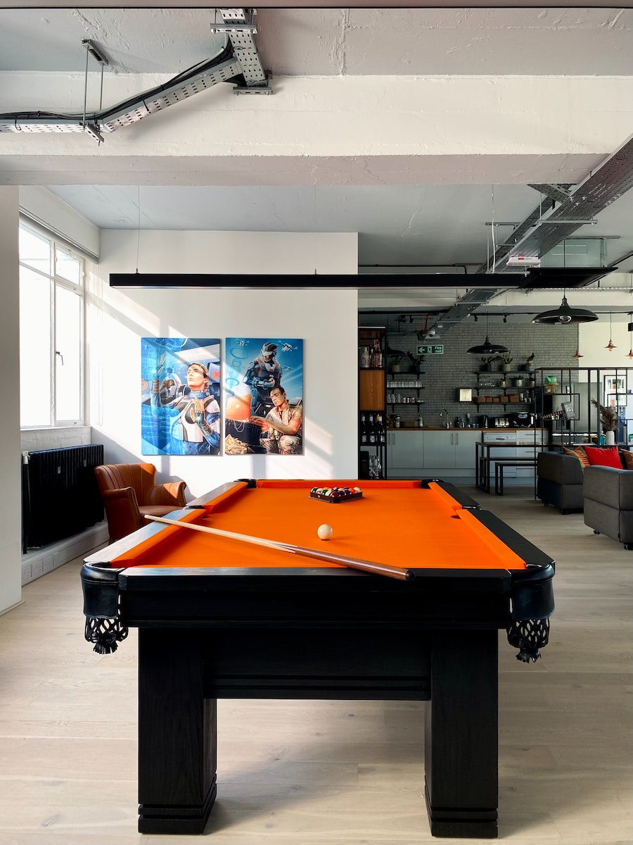 a pool table in a room with a couch